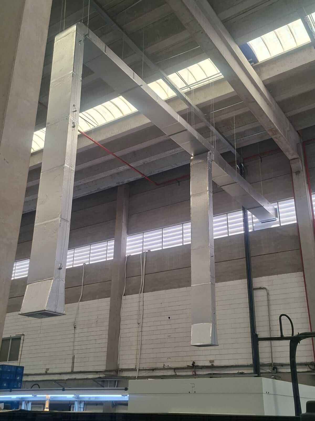 Torre de resfriamento industrial instalada em ambiente de fábrica, com estrutura metálica e dutos de.